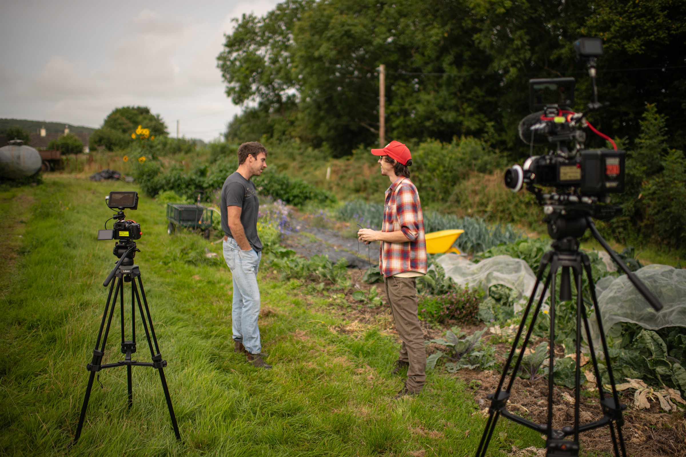 Shane Hatton directing a two-camera documentary interview in a market garden