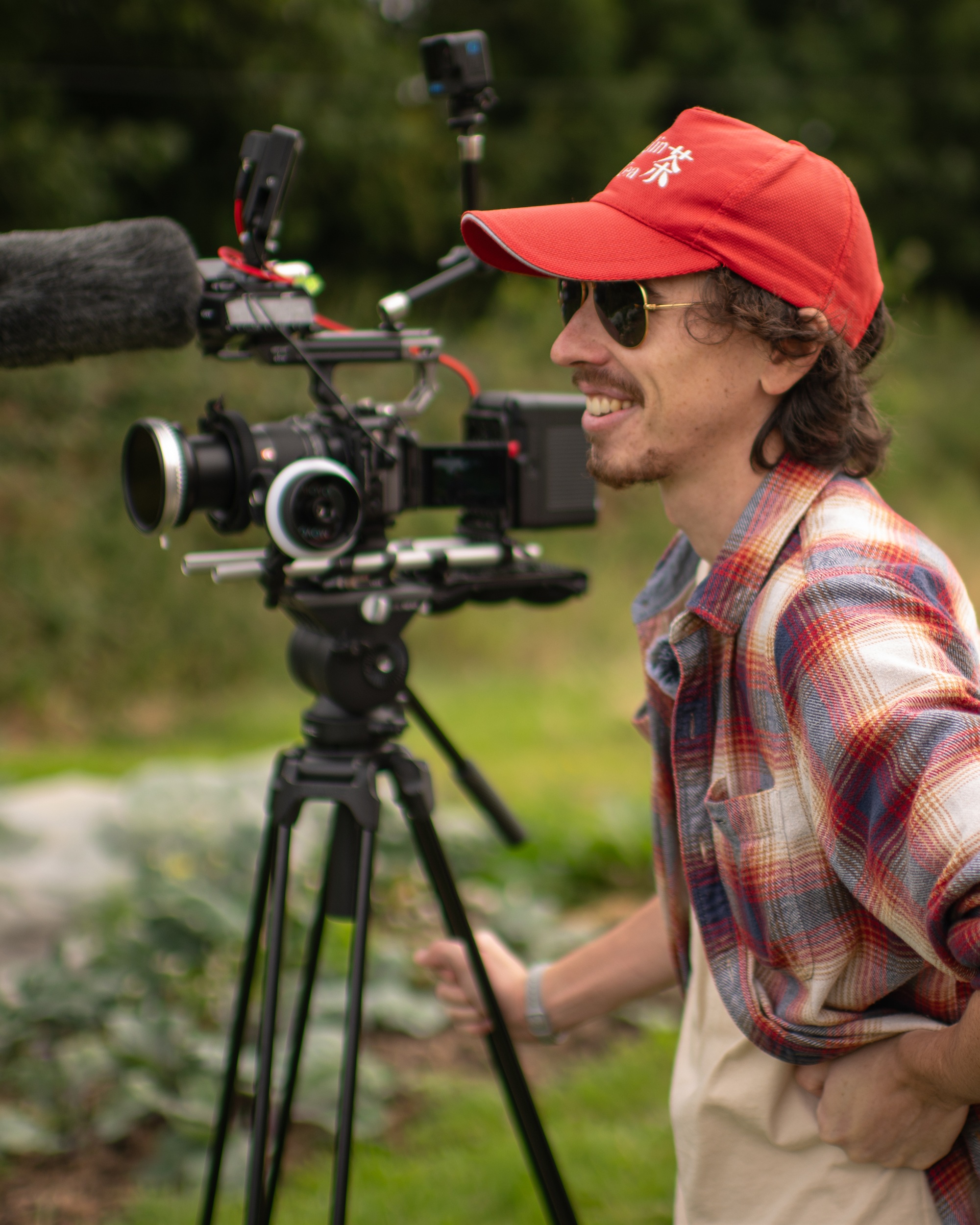 Shane Hatton beside a cinema camera during field production